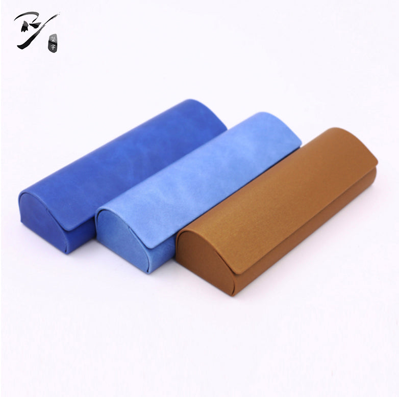 Handmade case with a rectangular arched silhouette, rounded corners, and a curved flap-over front
