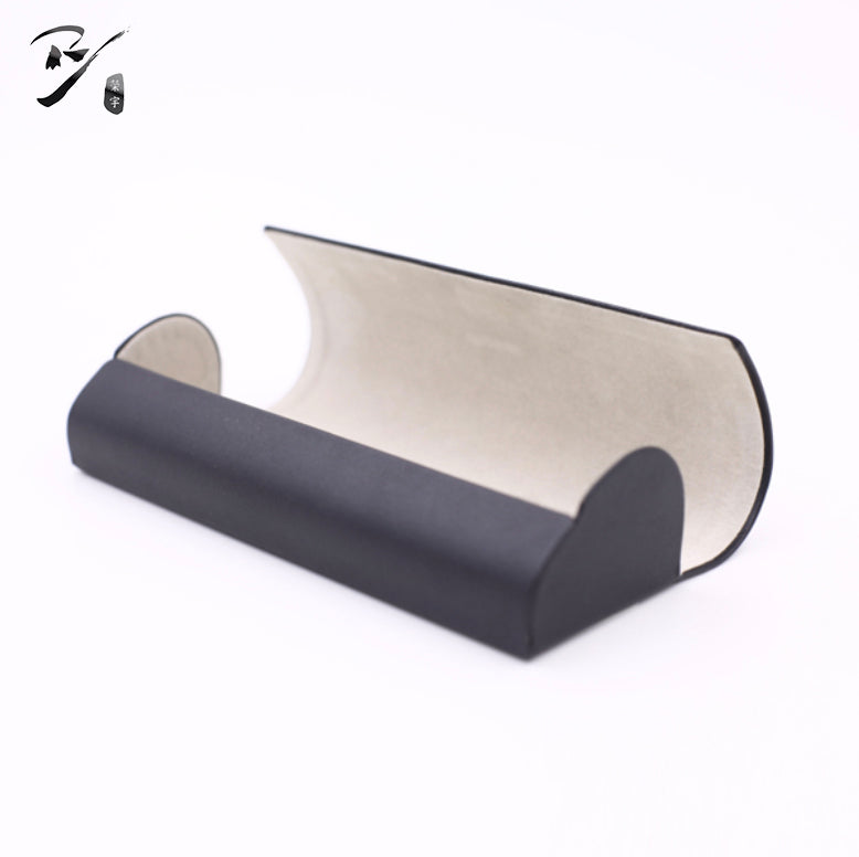 Open semi-cylindrical handmade eyewear case with rounded end panels.